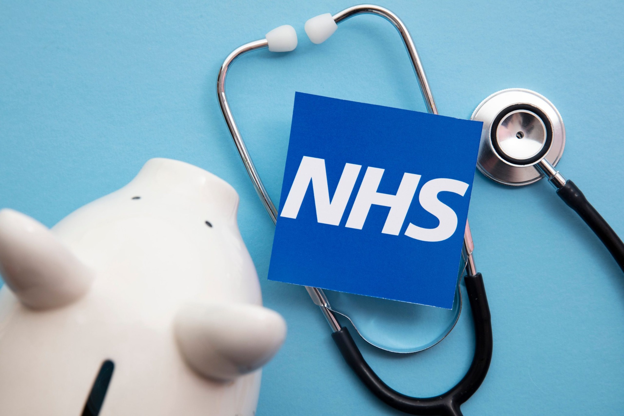 NHS card with a stethoscope and savings bank